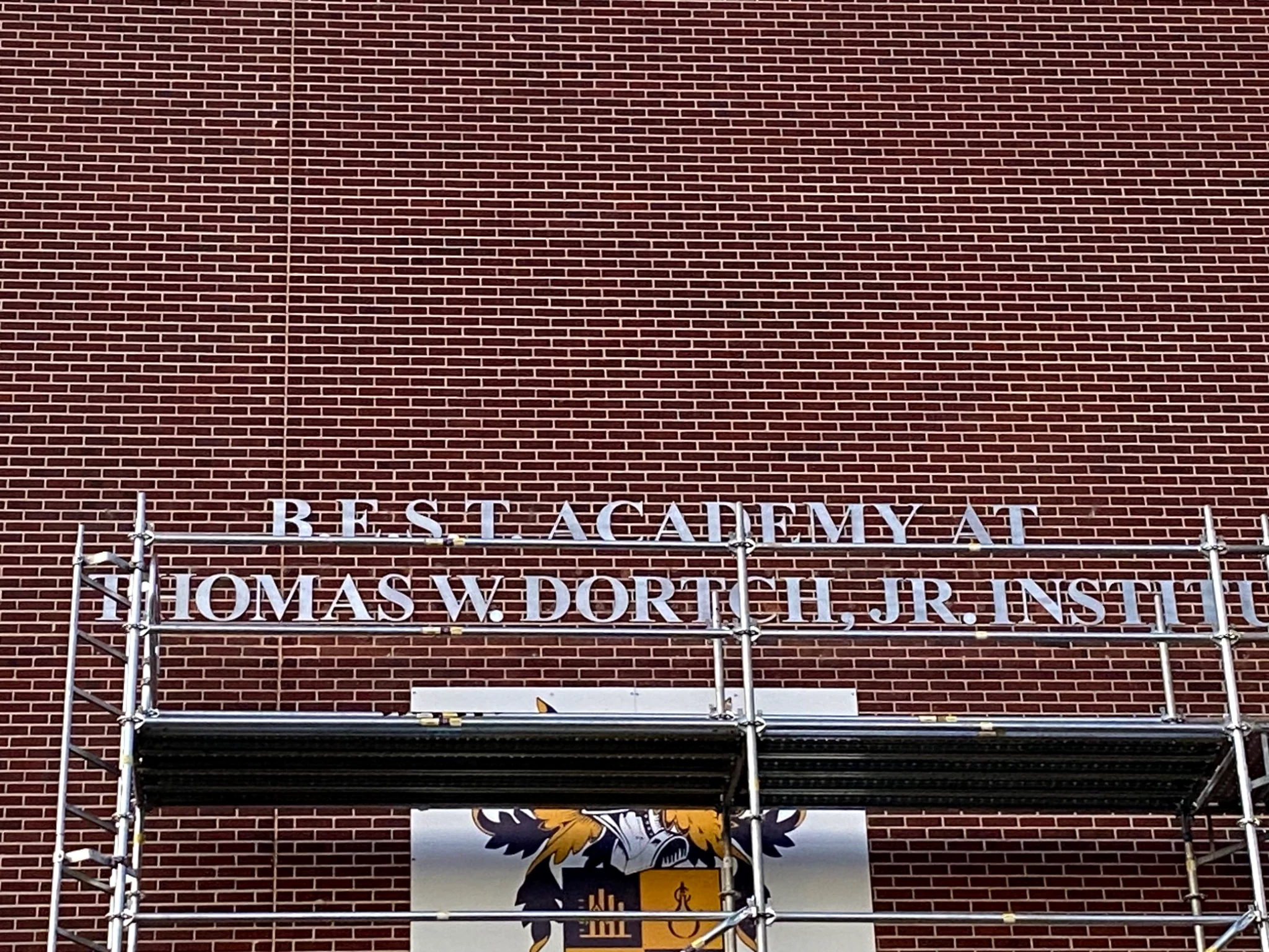 Dimensional lettering installed on a brick school building