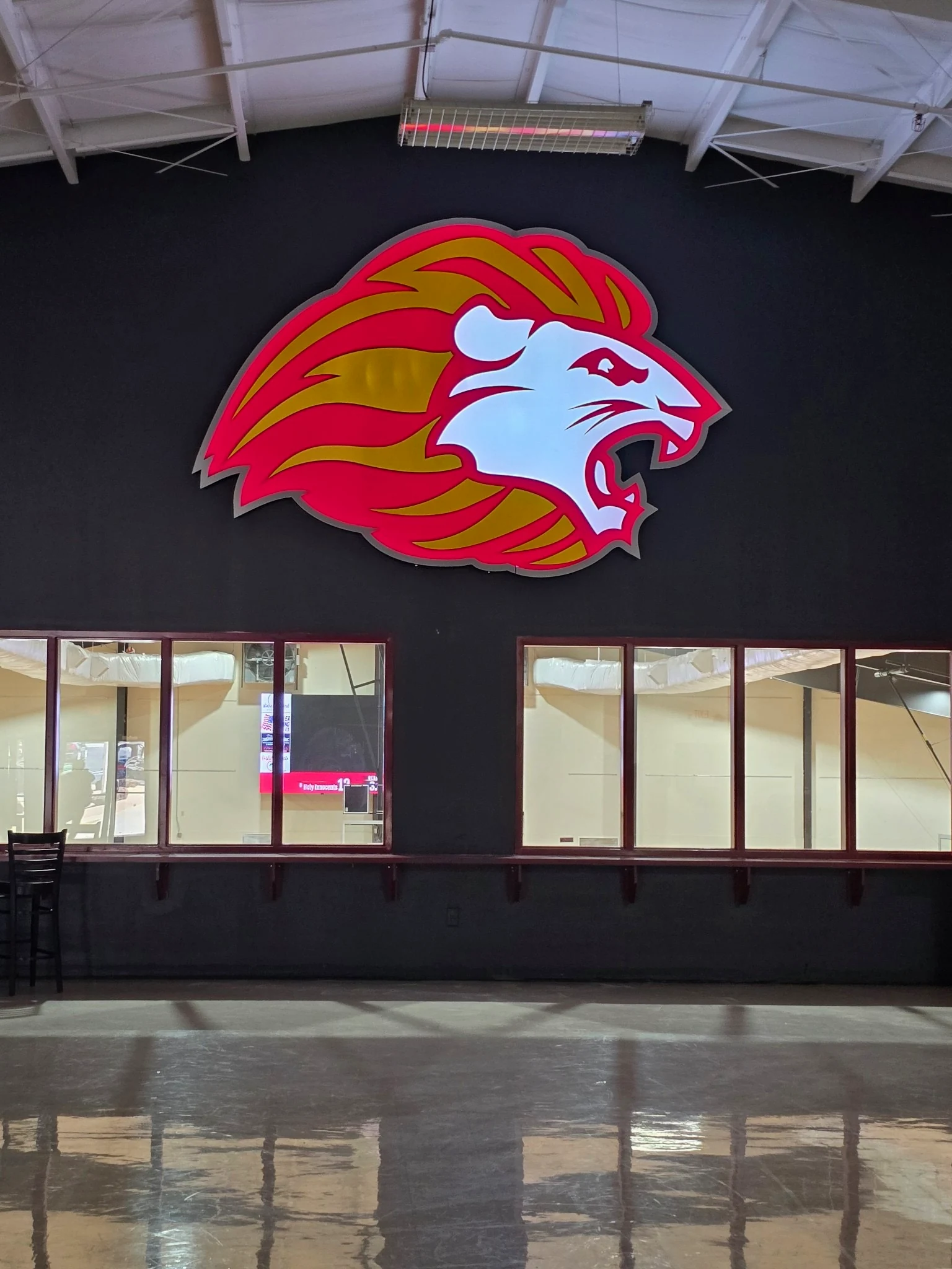 Large colorful athletics emblem mounted above interior windows